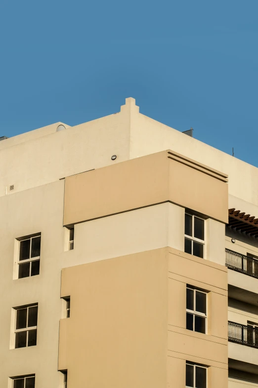 an old style building with balconies is against the blue sky