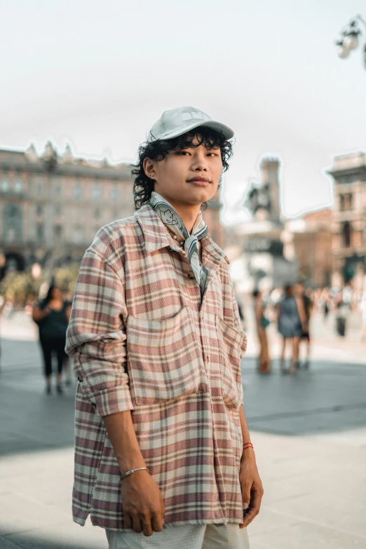 a man stands in the middle of a street and stares at the camera