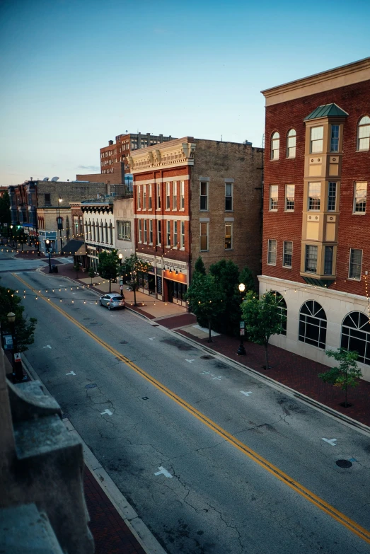 a city street has cars parked on both sides