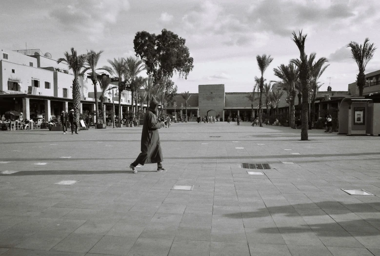 black and white pograph of people walking in the street