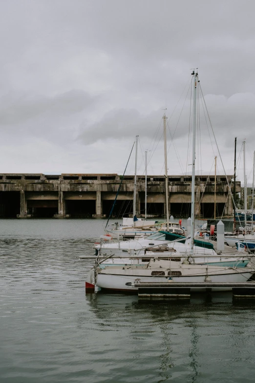 several sailboats are docked at the pier