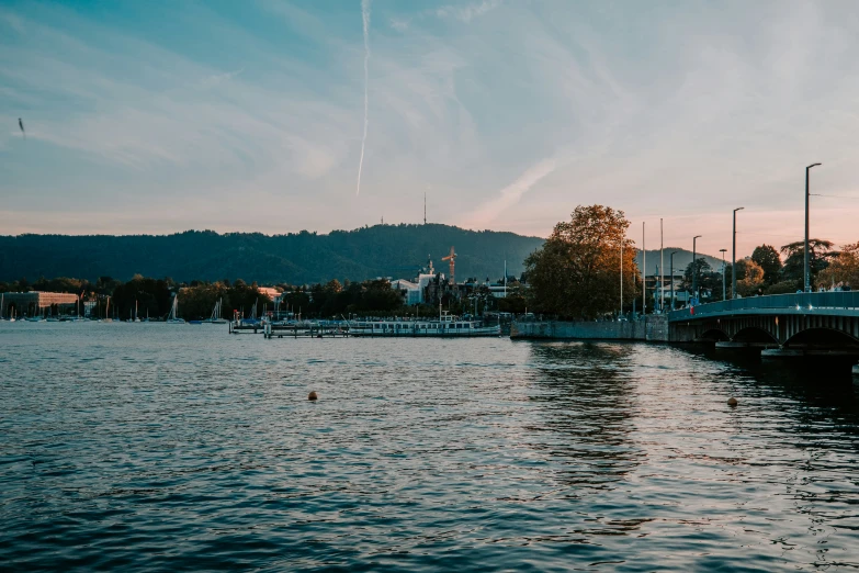 the pier in front of some buildings and a body of water