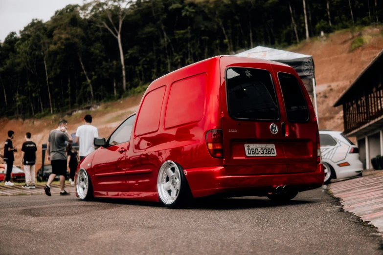 a van parked next to a trailer on the side of a road