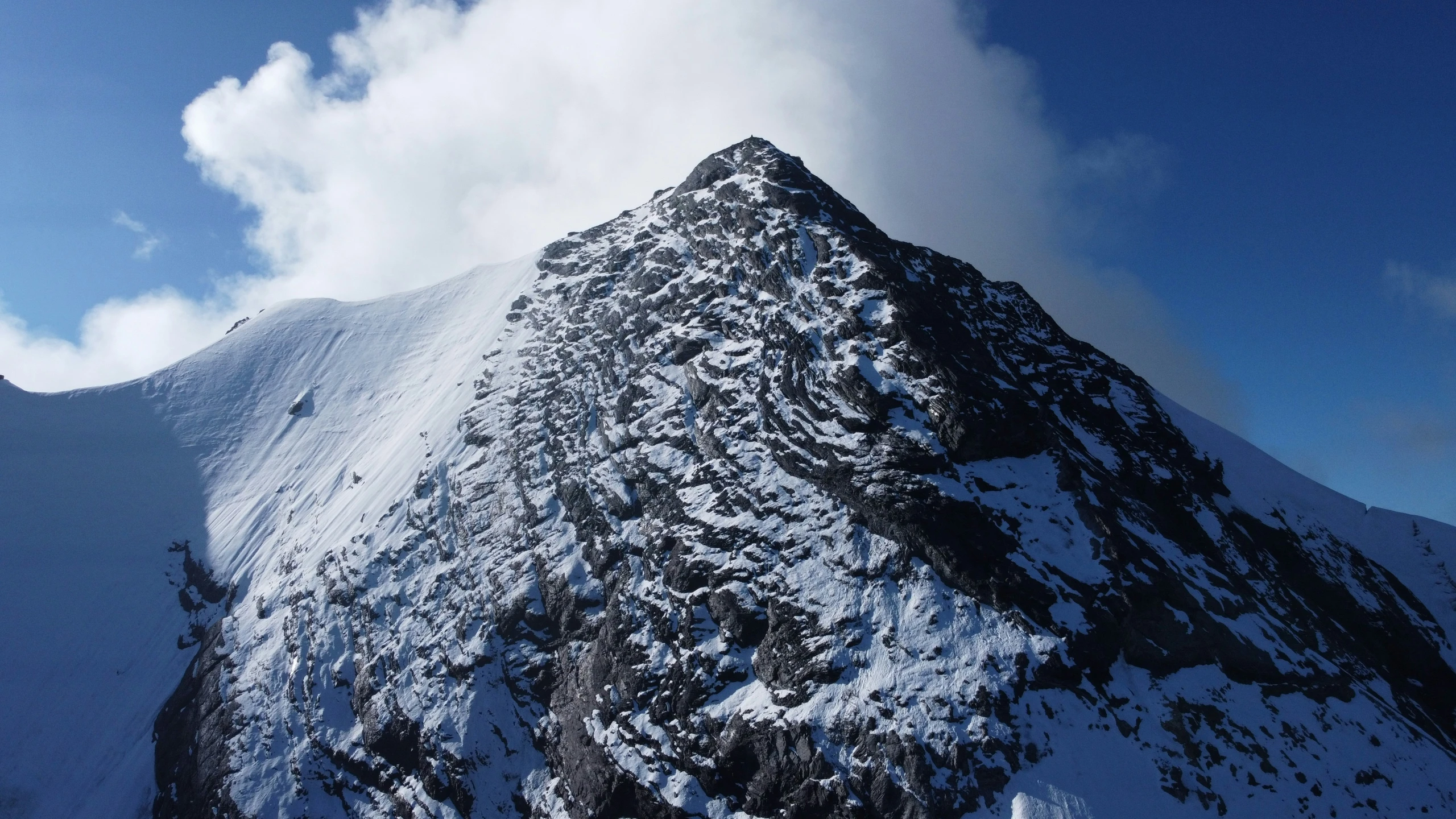 the peak of a snowy mountain in the sun