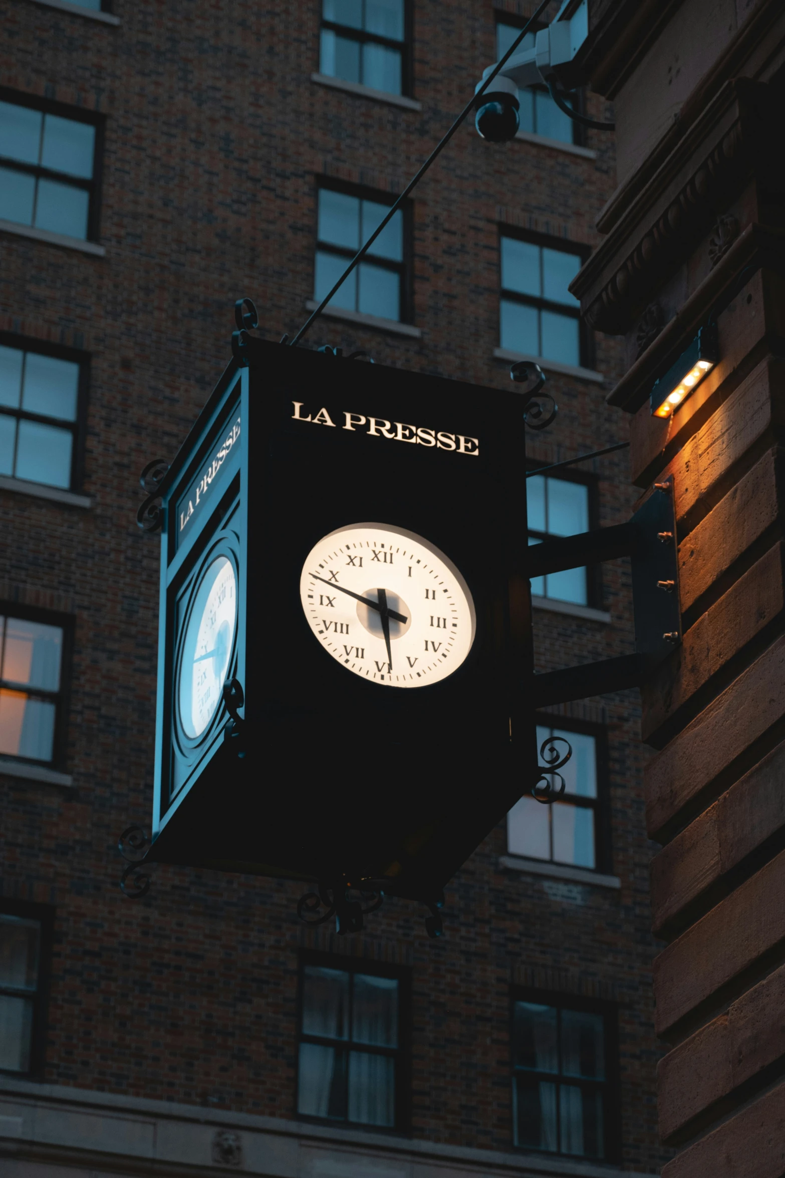 the large clock on the front of a building is lit up