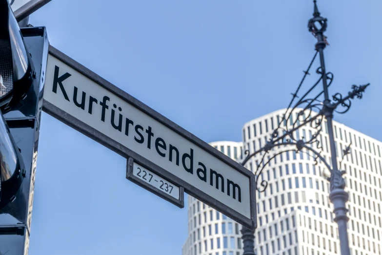 an urban intersection with street signs, wires and light posts