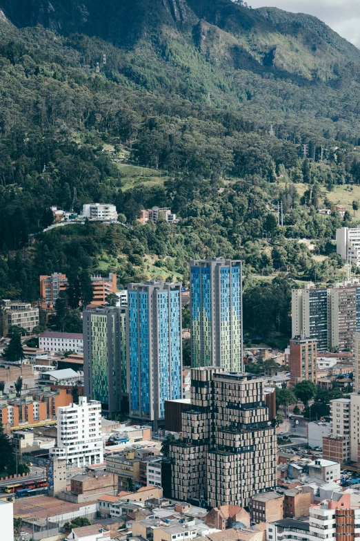 a view of buildings on a city, with a mountain in the background