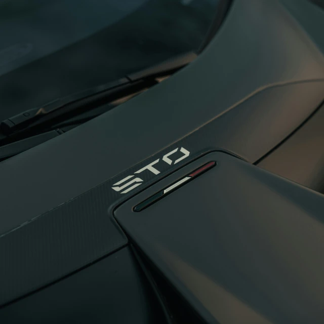 the hood of a sports car with carbon stripes