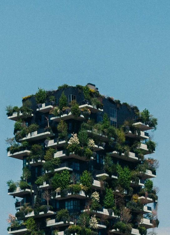 a very tall building filled with green plants and trees