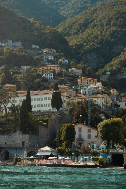 some buildings sitting on top of a hill above water