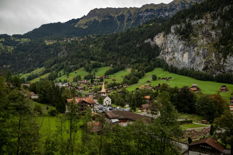 a town nestled on top of a large hill with trees in front of it