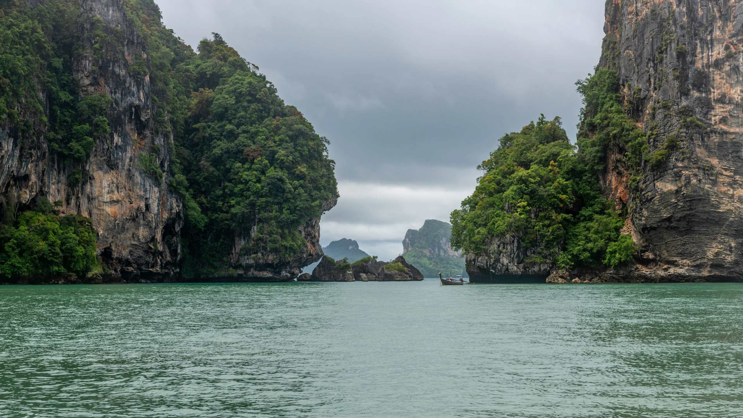 a body of water surrounded by tall mountains