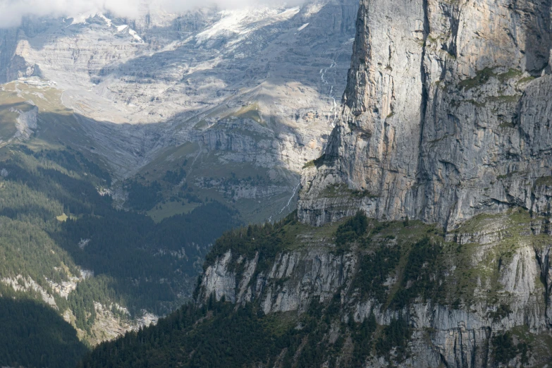 mountains are covered in a layer of green vegetation