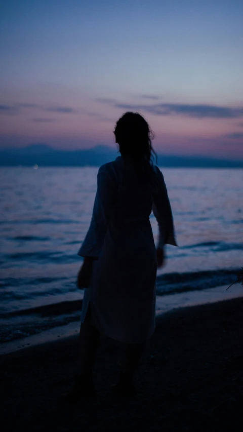 a person walking on the beach at night