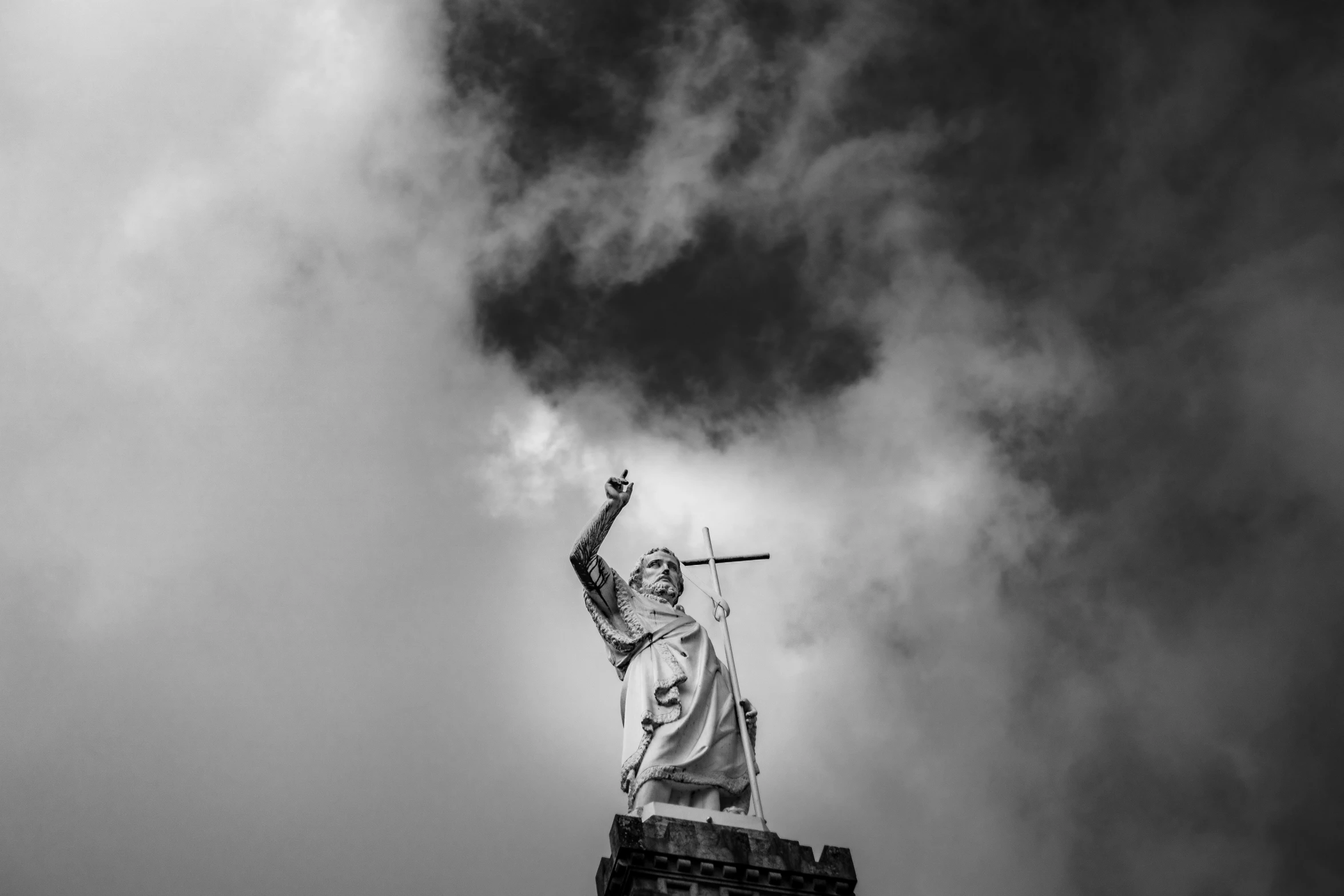 the statue of liberty is silhouetted against the cloudy sky