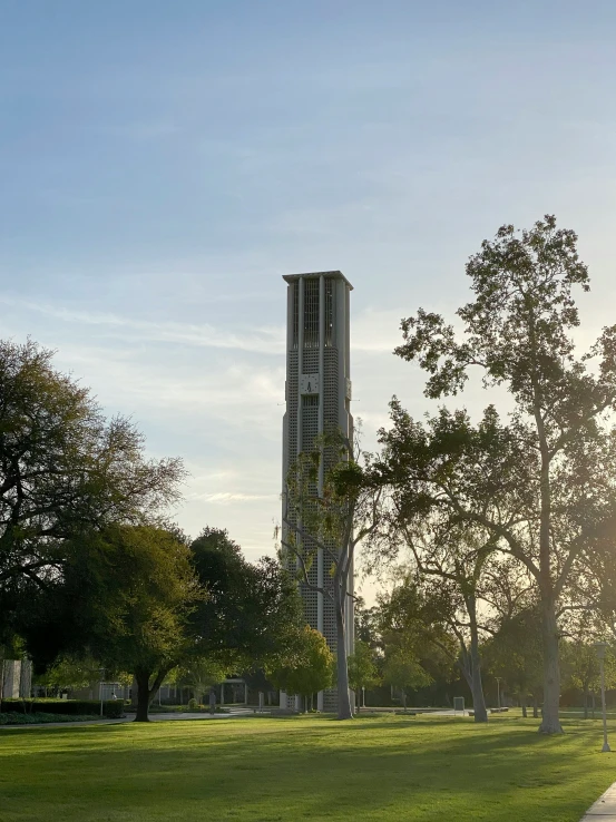 a tall tower sitting over a lush green field