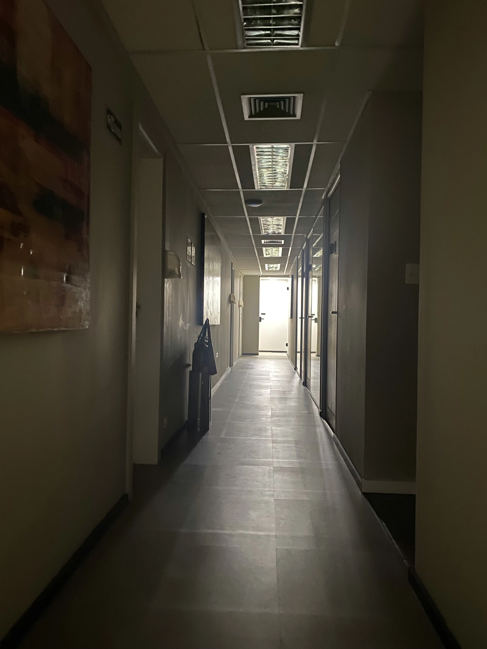 the hallway inside an office building with several doors