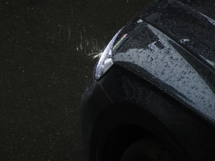 a black suv parked in the rain