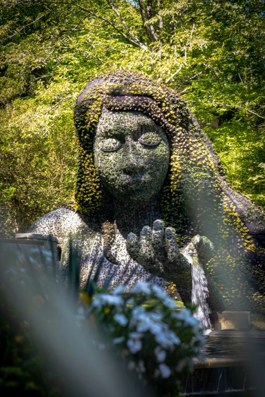 a statue in the shape of an angel holding a snake