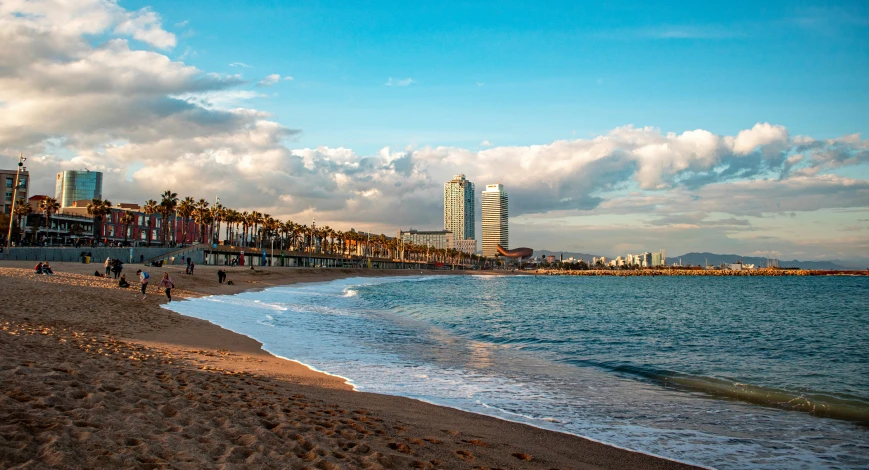 people walking on the beach near the ocean