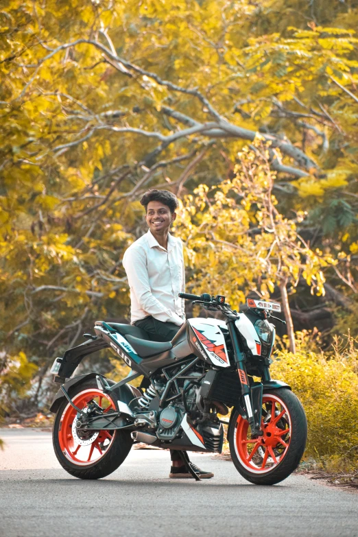 a smiling man on his bike in the street