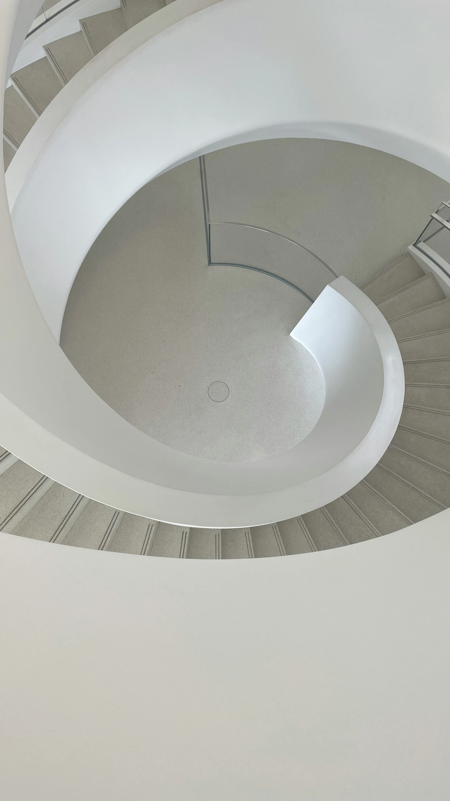 a spirally staircase is located inside of a building