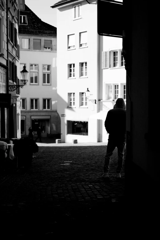 a person walking toward an apartment building from outside