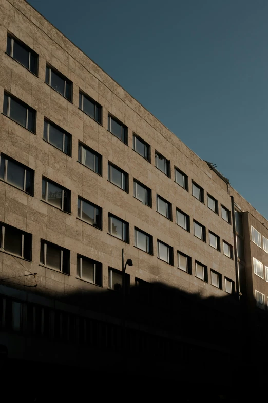 an architectural building is silhouetted against a clear sky