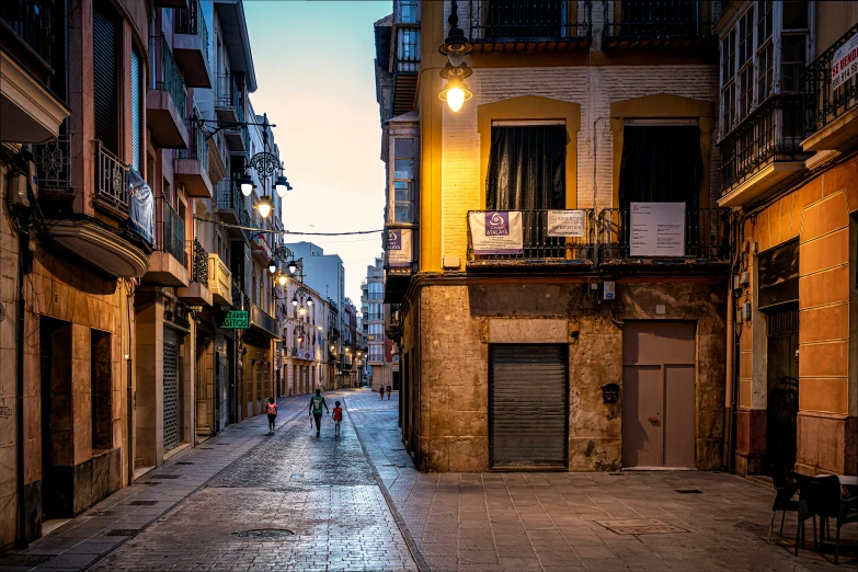 a street scene showing two people walking in an alley