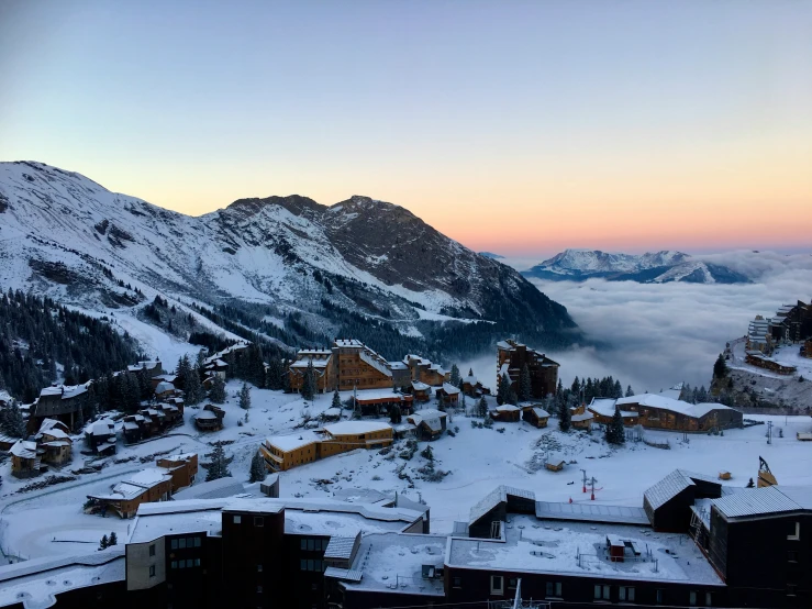 a snowy town with a lot of mountains in the background