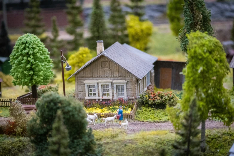 a tiny toy house with people playing outside