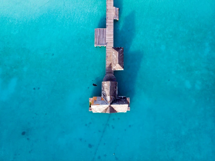 a view of a dock from above in the water