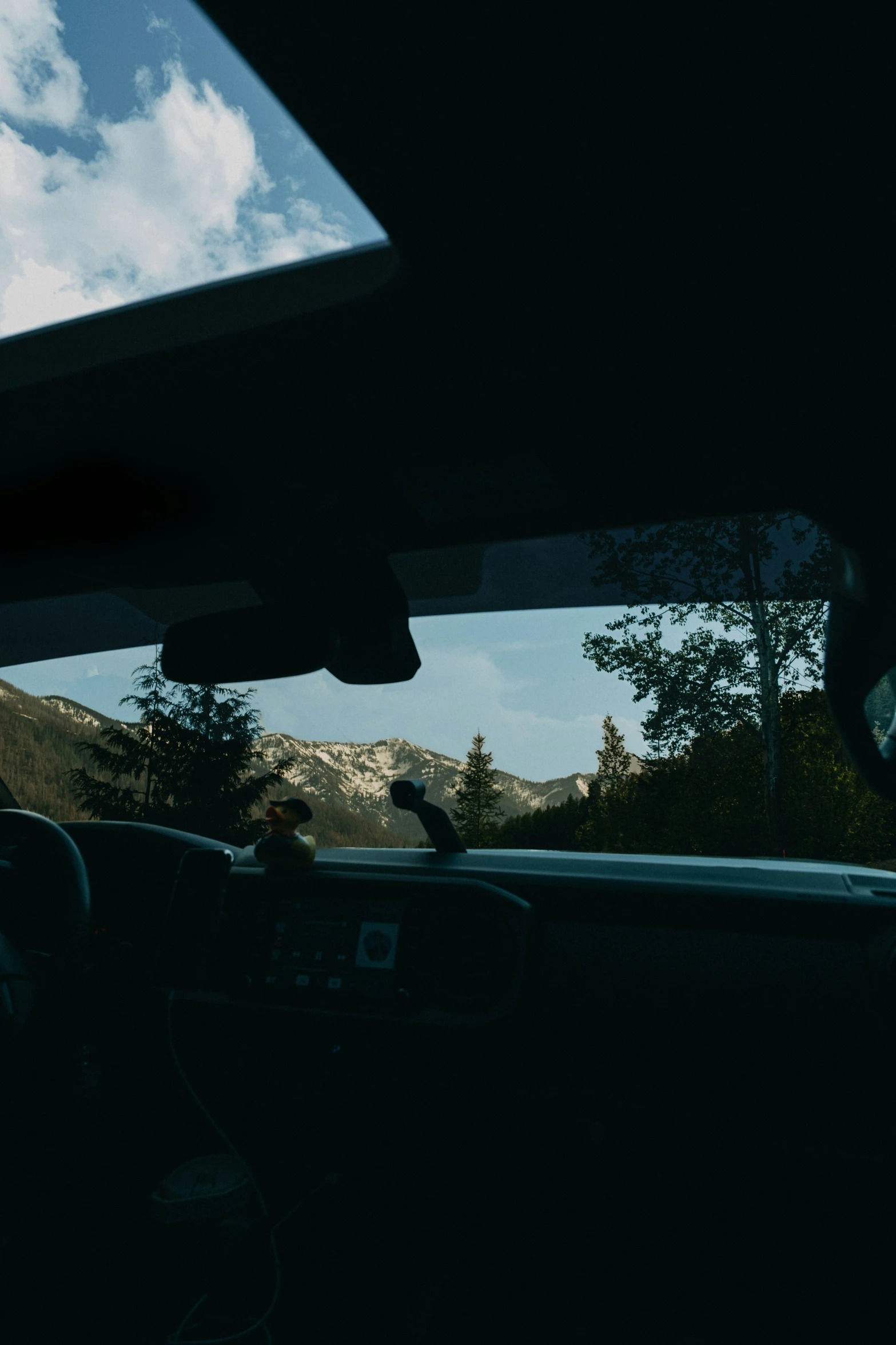 a car drives on a mountain road at dusk