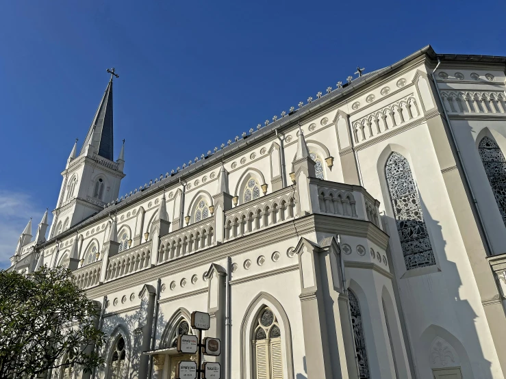 an ornate old building with a spire and clock on it