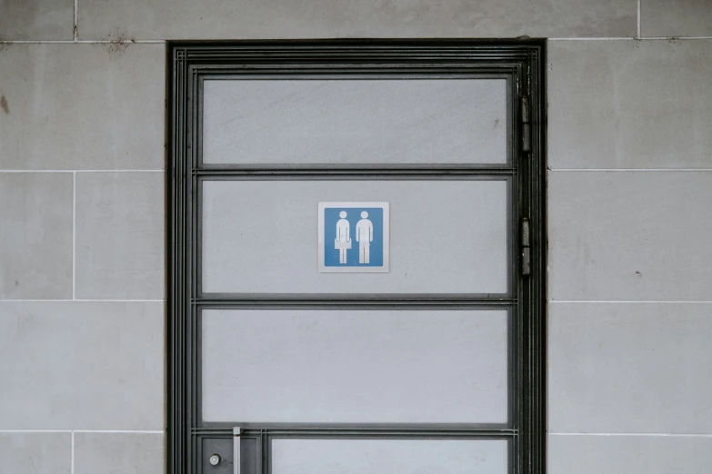 a close up view of an open door with a toilet sticker on it