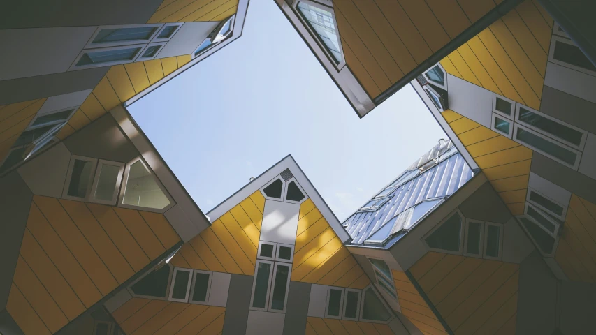 a tall tower with windows that is yellow and gray