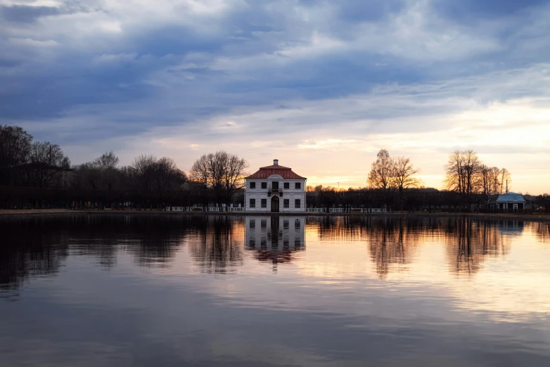 the house is sitting at the edge of a small lake