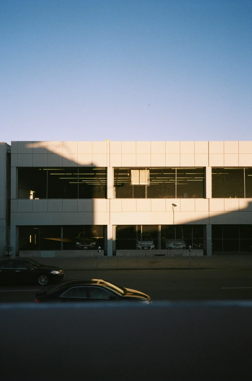 cars drive past a parking garage with no doors