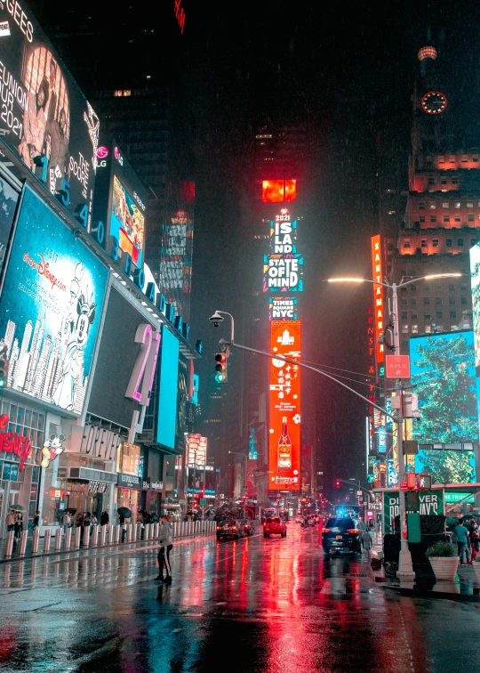 city street lit up in neon colors during the rain