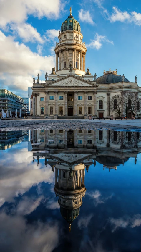 large building with a dome on the top near a river