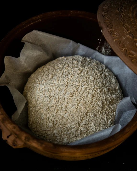 the bread is placed in the wooden bowl