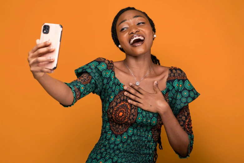 a woman is making an angry face holding a cell phone