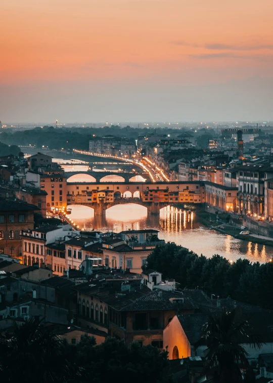 city with lots of bridges lit up during twilight