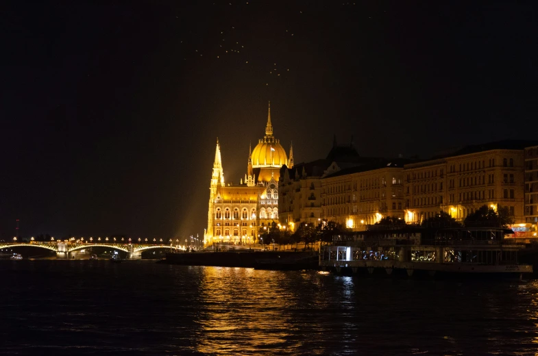 a very tall castle like building sitting next to the water