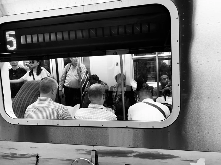 a group of people in the subway looking at their surroundings