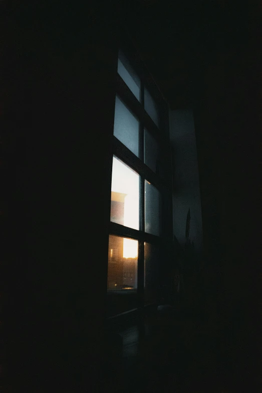 dark room with a window showing the light coming in