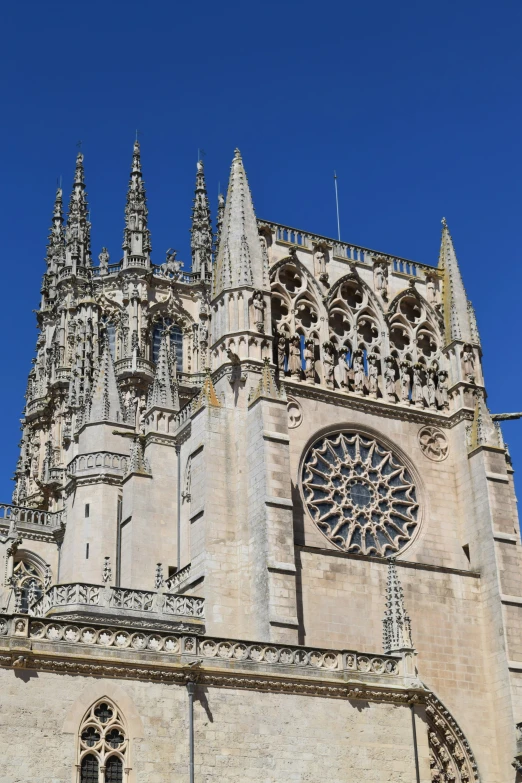 a large cathedral with three pointed spires against the blue sky