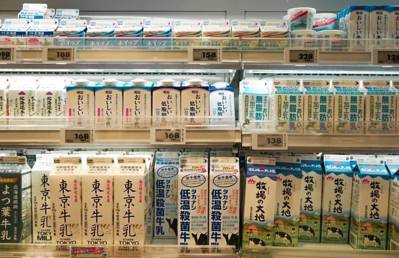 milks are stacked on display in a store