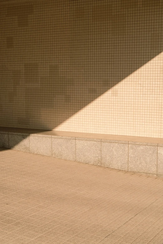 shadow from a brick wall on a sidewalk