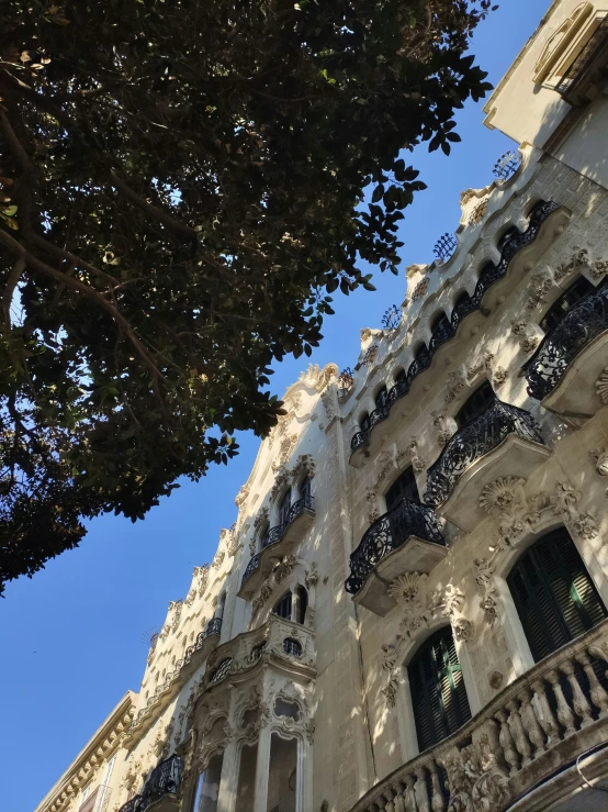 a large white and gray building with balconyes